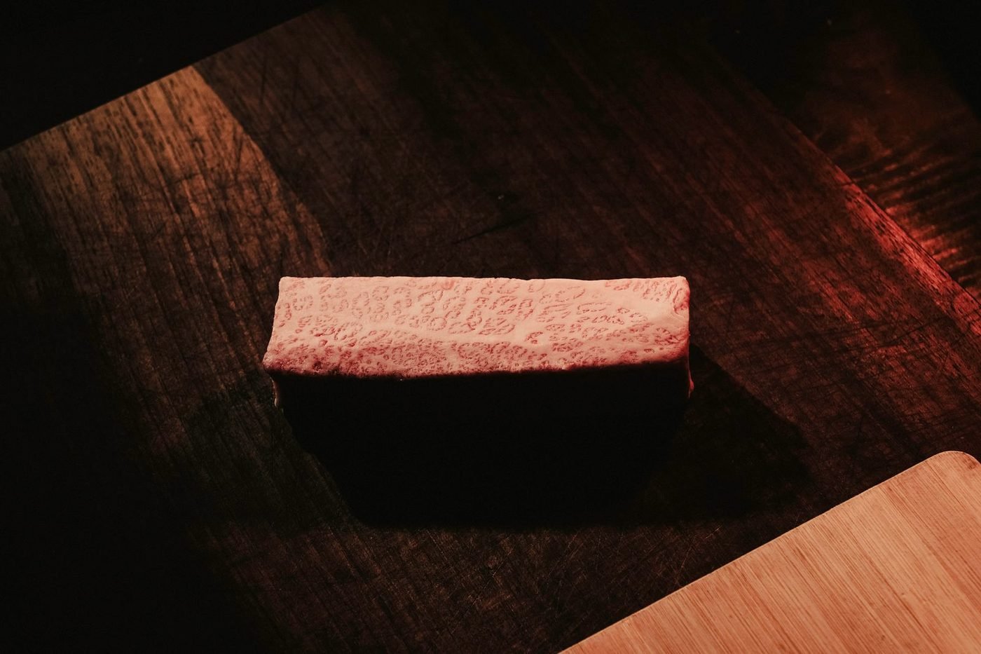 A cut of beef on a wooden board