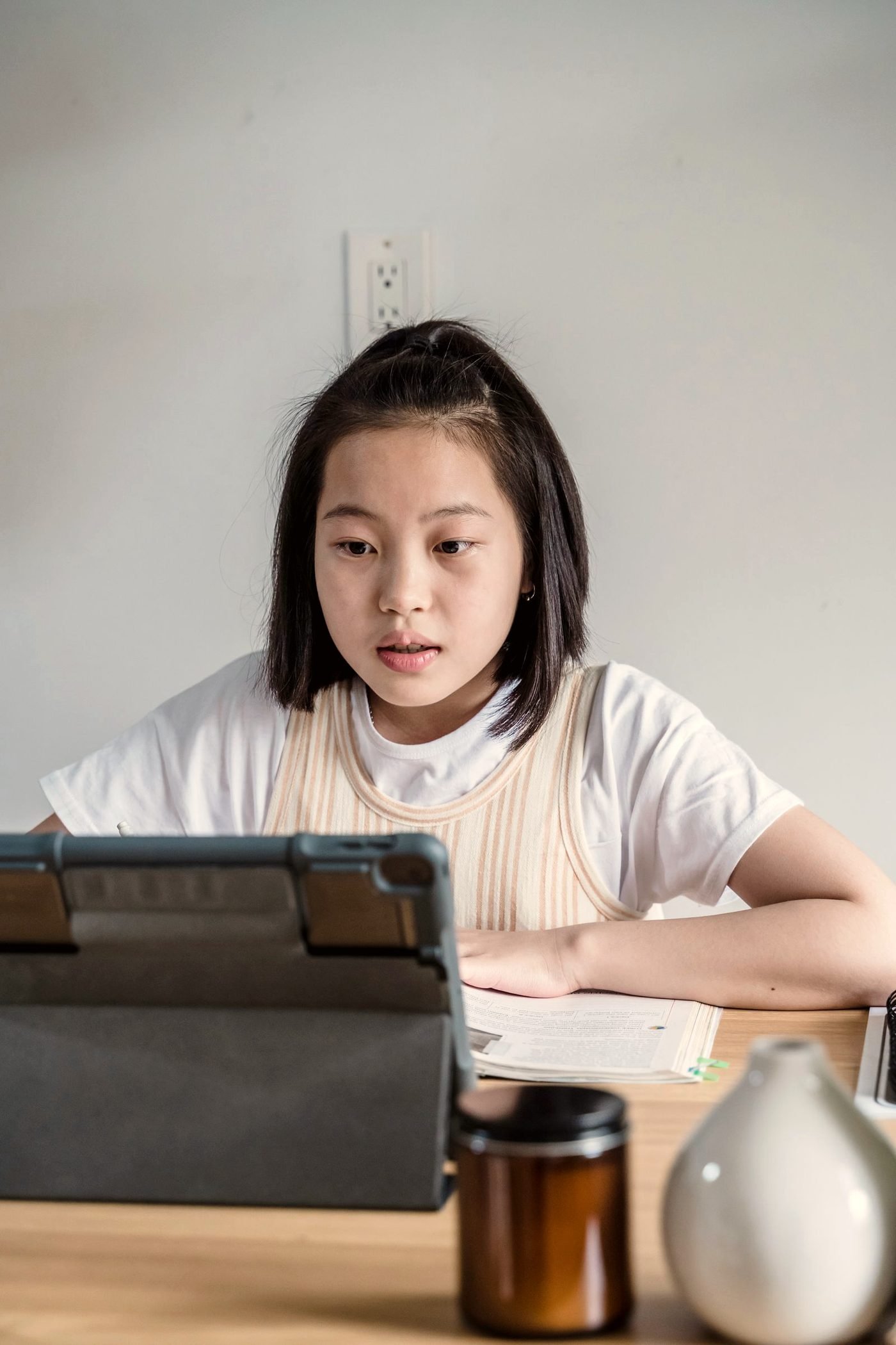 A child working on a electronics project at a table