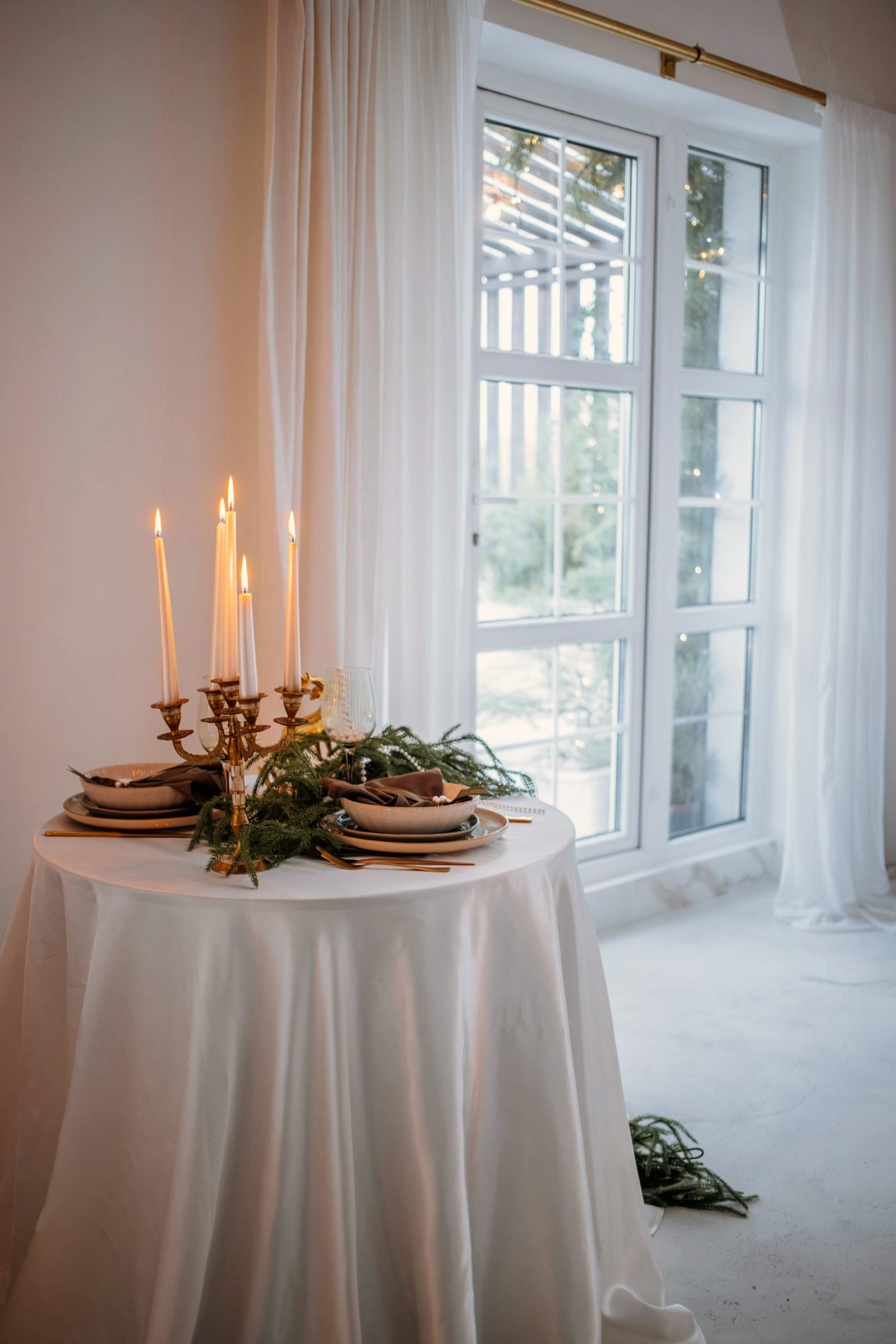 Lit candles arranged by a window