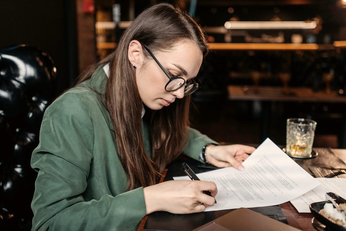 A desk with documents, a pen and a notebook